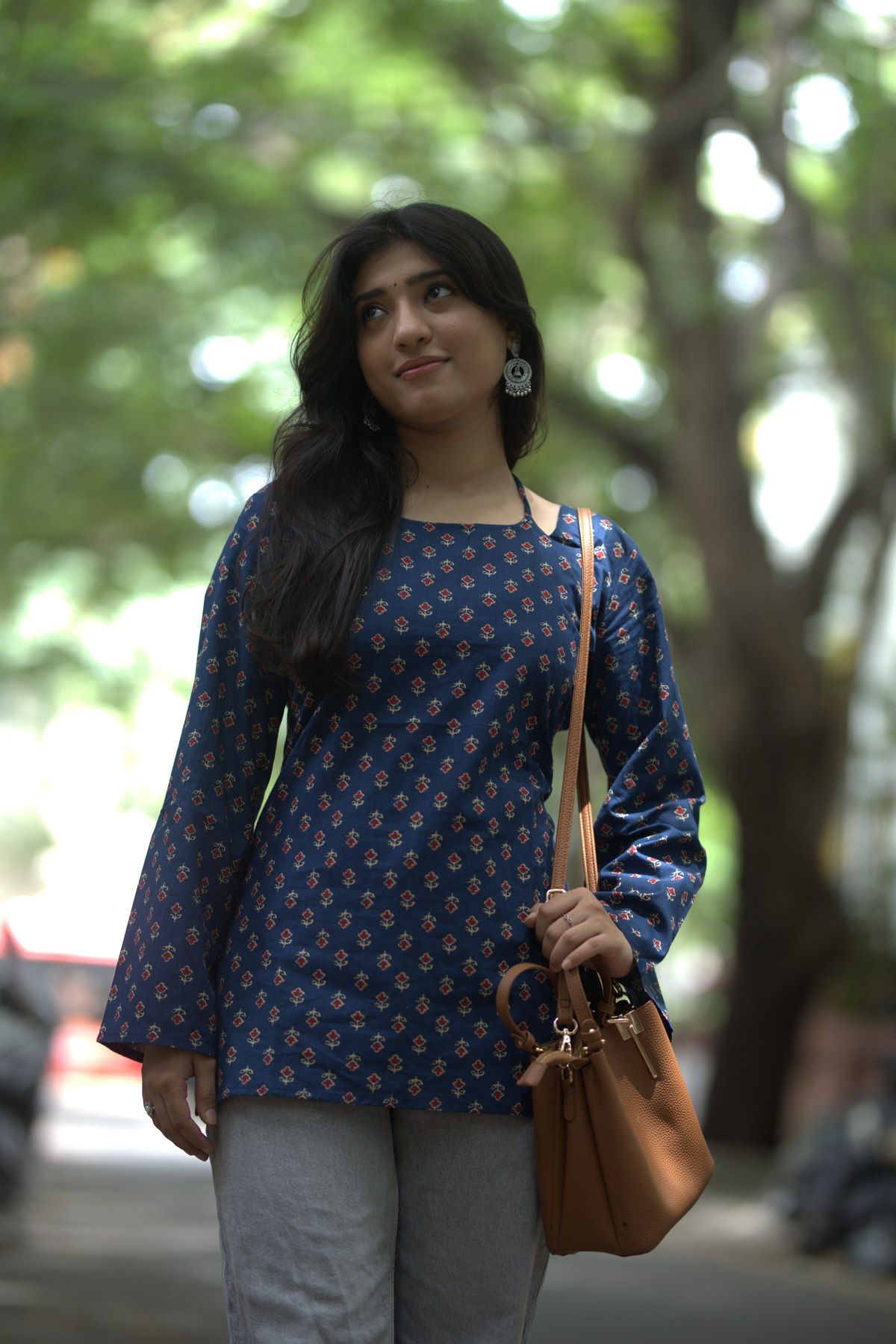 Indigo buti-print top worn with grey trousers
